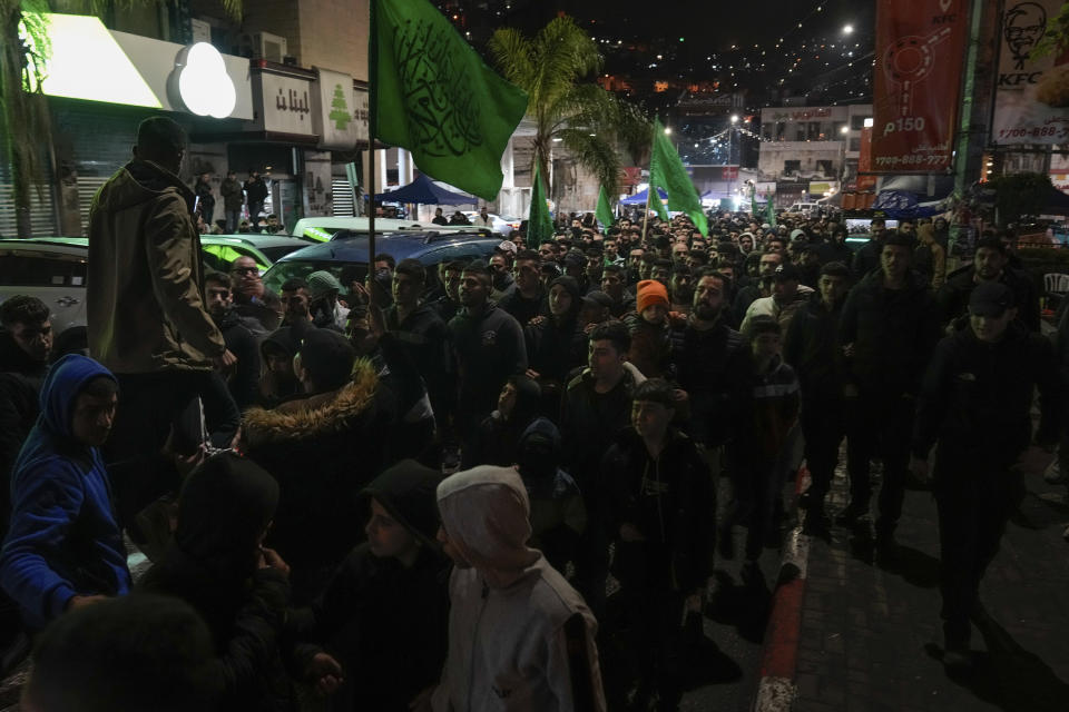 Palestinian demonstrators wave Hamas flags and shout slogans during a protest following the killing of top Hamas official Saleh Arouri in Beirut, in the West Bank city of Nablus on Tuesday, Jan. 2, 2024. Arouri, the No. 2 figure in Hamas, was killed in an explosion blamed on Israel. He is the highest-ranked Hamas figure to be killed in the nearly three-month war between Israel and Hamas. (AP Photo/Majdi Mohammed)