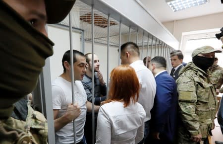 Crew members of Ukrainian naval ships, which were seized by Russia's FSB security service in November 2018, attend a court hearing in Moscow