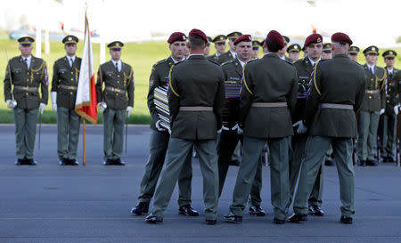 Soldiers carry a coffin with the remains of Czech cardinal Josef Beran after its arrival to Kbely airport in Prague, Czech Republic, April 20, 2018. REUTERS/David W Cerny