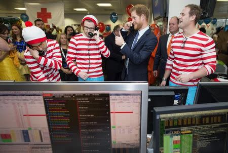 Britain's Prince Harry takes part in a charity trading day at ICAP on the Aus/Nz forwards Desk with Jack O'Brien and Phil McMahon in support of his charity Sentebale, in London, December 7, 2016. REUTERS/Geoff Pugh/Pool