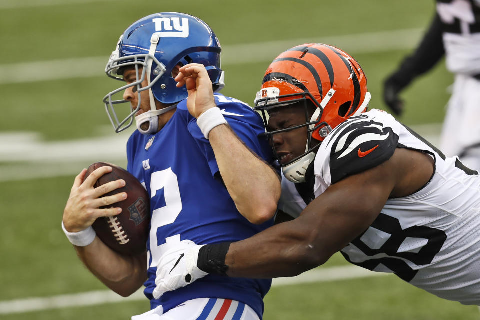 New York Giants quarterback Colt McCoy (12) is tackled by Cincinnati Bengals defensive end Carl Lawson (58) during the second half of NFL football game, Sunday, Nov. 29, 2020, in Cincinnati. (AP Photo/Aaron Doster)