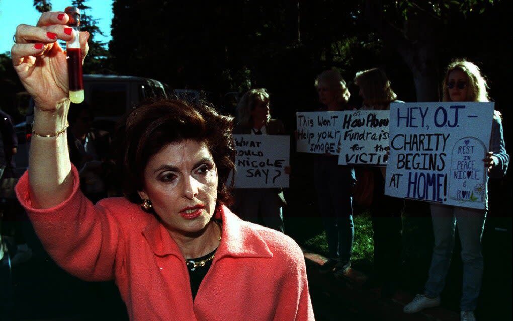 Gloria Allred, holding a vial of blood as a symbolic protest against OJ Simpson - AFP