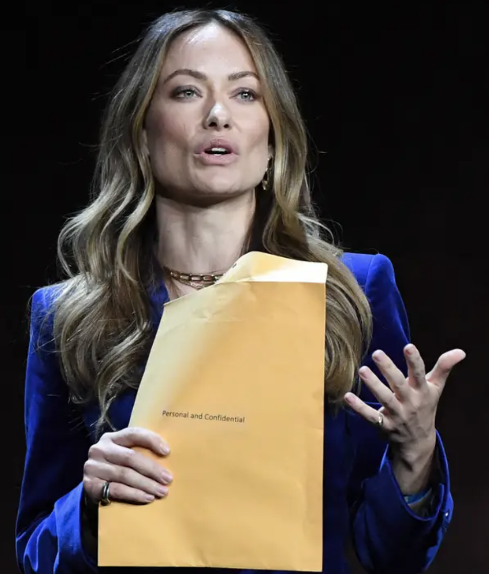 Olivia holding a large manila envelope stamped "Personal and Confidential"