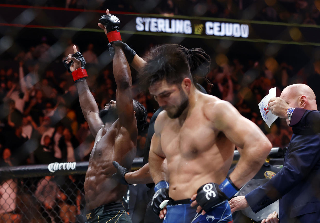 NEWARK, NEW JERSEY - MAY 06: Aljamain Sterling of Jamaica (left) celebrates his victory over Henry Cejudo (right) during their bantamweight title bout at UFC 288 at Prudential Center on May 06, 2023 in Newark, New Jersey. Sterling won by judge's decision. (Photo by Sarah Stier/Getty Images)