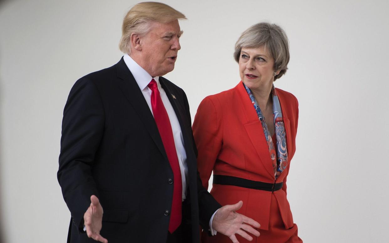 US President Donald Trump and British Prime Minister Theresa May walk at the White House on January 27, 2017 - AFP