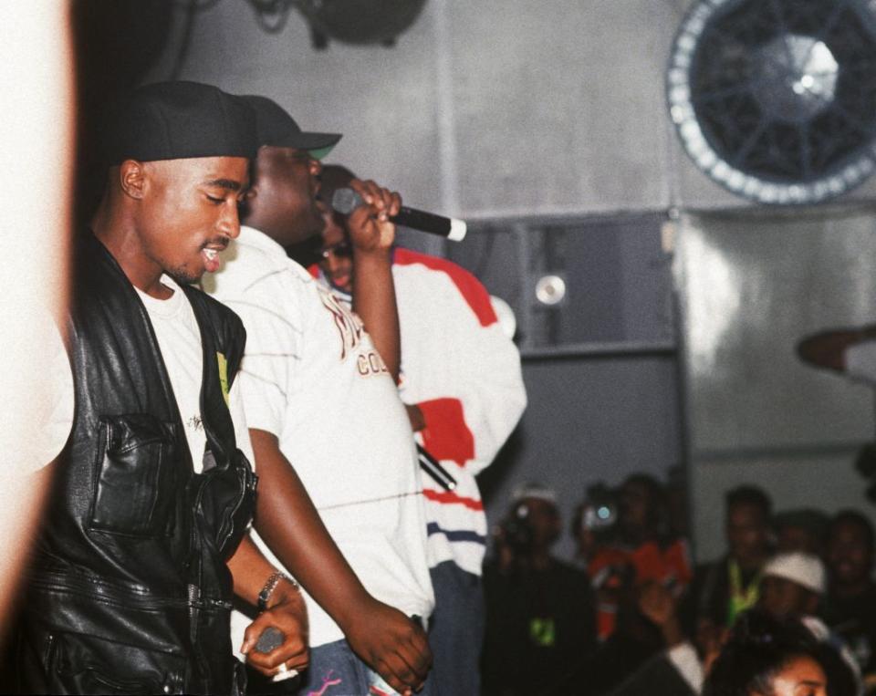 Rappers Tupac Shakur and The Notorious B.I.G. can be seen performing together on stage. 