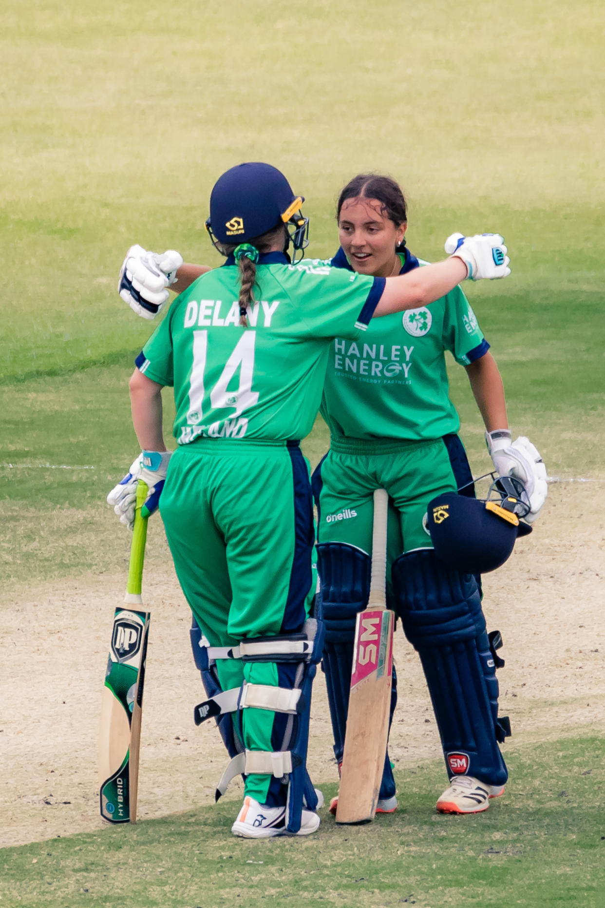 Amy Hunter celebrates her maiden century with her captain Laura Delany