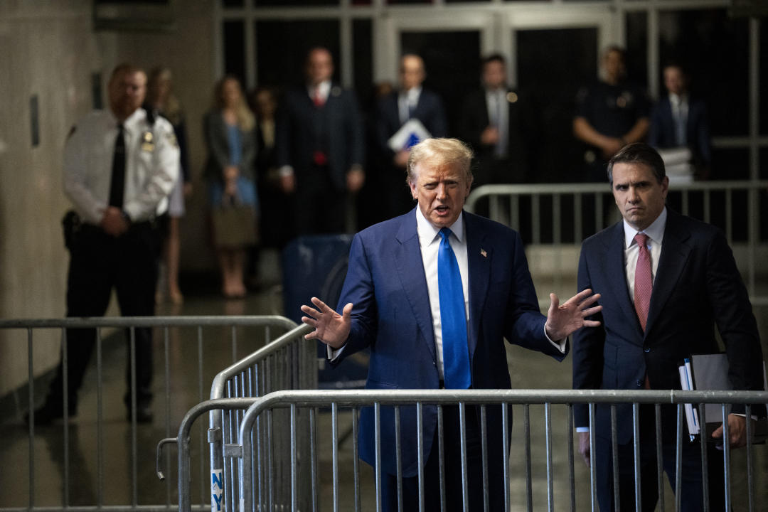  Donald Trump talks to reporters, alongside attorney Todd Blanche, right.