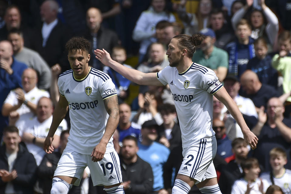 Leeds United's Luke Ayling, right, celebrates with teammate Rodrigo after scoring his side's opening goal during the English Premier League soccer match between Leeds United and Newcastle United at Elland Road in Leeds, England, Saturday, May 13, 2023. (AP Photo/Rui Vieira)