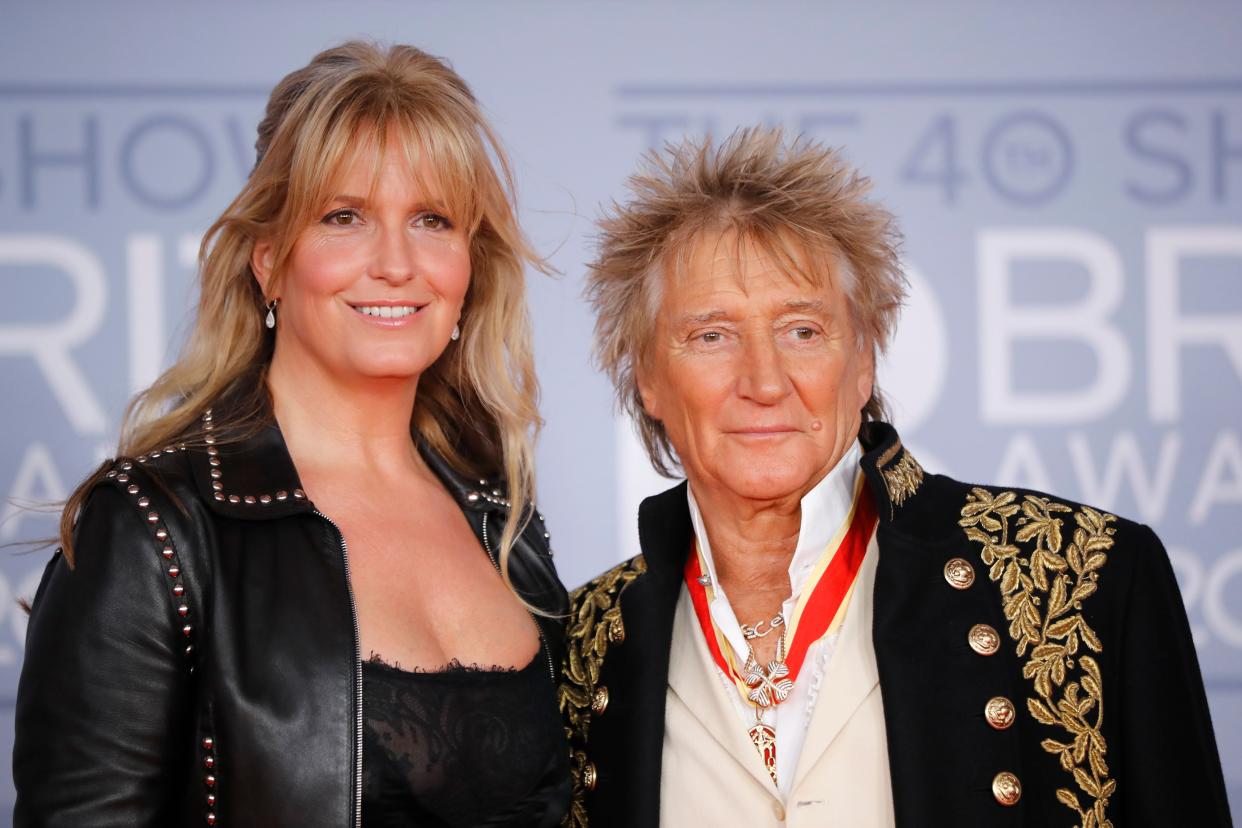 Rod Stewart (R) and his wife Penny Lancaster (L) pose on the red carpet on arrival for the BRIT Awards 2020 in London on February 18, 2020. (Photo by Tolga AKMEN / AFP)