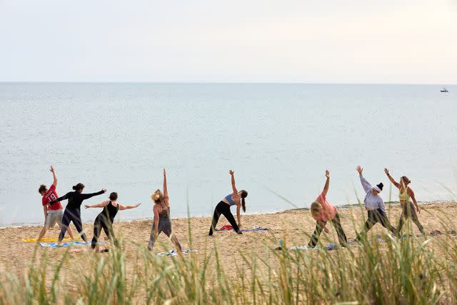 <p>Elizabeth Cecil</p> Yoga on the Vine's morning class on Bend in the Road Beach, in Edgartown.