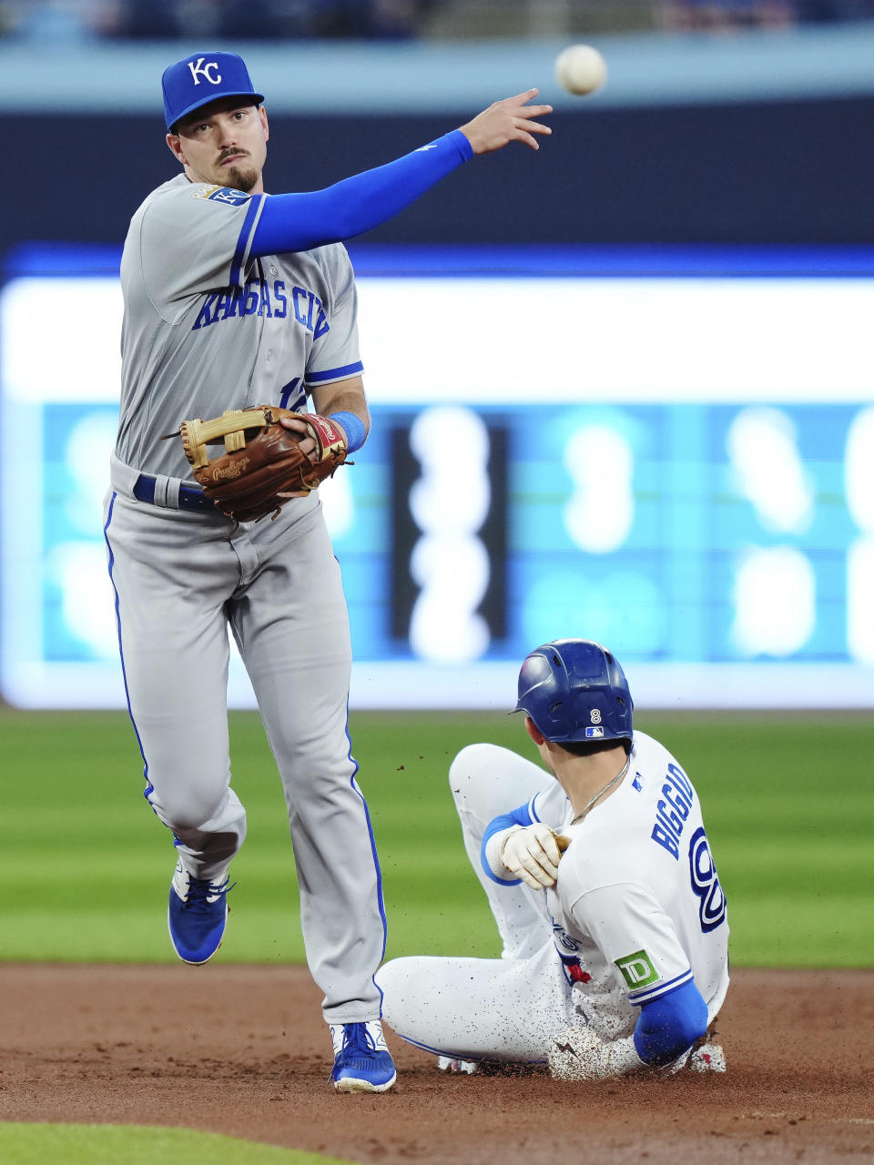Kansas City Royals second baseman Nick Loftin throws to first after forcing out Toronto Blue Jays' Cavan Biggio (8) on a double play hit into by White Merrifield during the second inning of a baseball game Friday, Sept. 8, 2023, in Toronto. (Nathan Denette/The Canadian Press via AP)