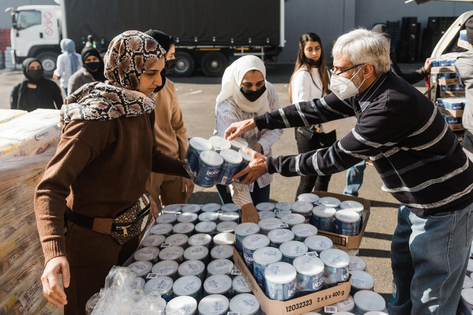 Image: A volunteer from Muslims For Humanity pack baby food at the NMJ Islamic Centre to distribute to members of the public in Durban, South Africa (Rajesh Jantilal / AFP - Getty Images)