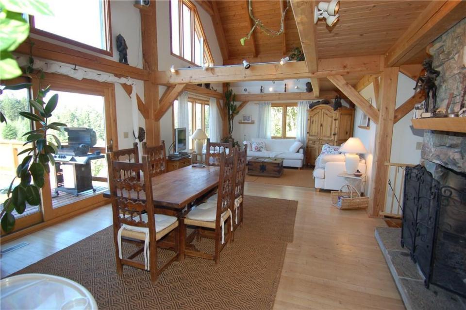 <p><span>4895 Arnold Rd., Golden, B.C.</span><br>The timber-frame house has four floors and unique features, such as this rock fireplace.<br>(Photo: Zoocasa) </p>