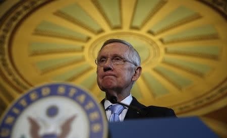 Senate Majority Leader Harry Reid speaks to reporters after the Democratic party policy luncheon in the Capitol in Washington September 16, 2014. REUTERS/Kevin Lamarque