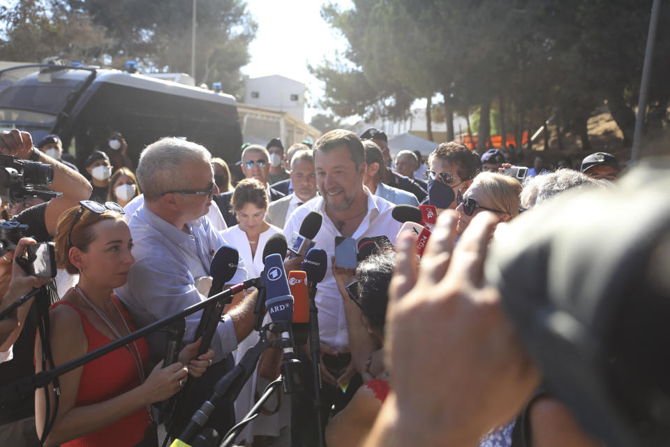 Italy's former Interior minister, Matteo Salvini and Leader of The League party, center, talks to journalists after visiting the migrant reception center in the Sicilian Island of Lampedusa, Italy, Thursday, Aug. 4, 2022. Salvini is making a stop Thursday on Italy's southernmost island of Lampedusa, the gateway to tens of thousands of migrants arriving in Italy each year across the perilous central Mediterranean Sea. (AP Photo/David Lohmueller)