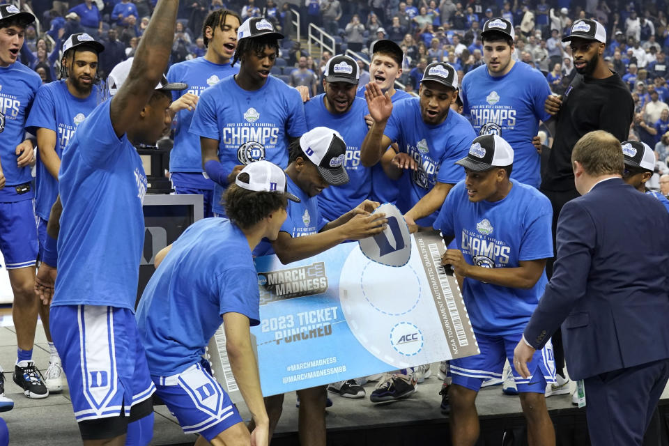 Duke players "punch their ticket" to the NCAA Tournament after their win over Virginia in an NCAA college basketball game for the championship of the men's Atlantic Coast Conference Tournament in Greensboro, N.C., Saturday, March 11, 2023. (AP Photo/Chuck Burton)