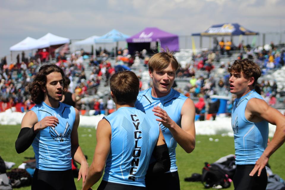 Ryan King (left), Evan Lujan (center), Gavin Lockett (right) and Keishaun Gylling (center) celebrate after qualifying for the 4x100-meter finals at the 2022 CHSAA state track and field meet held at Jeffco Stadium on May 21, 2022.