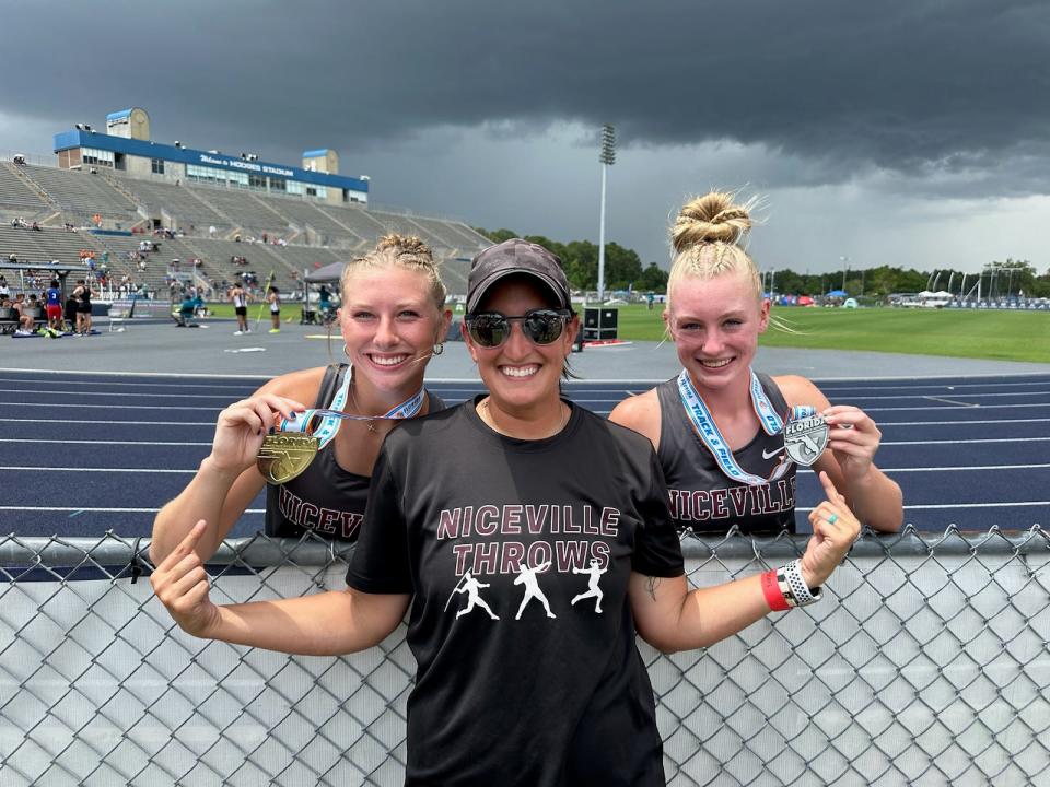 Javelin state champion Elaina Perks, left, and teammate and 7th-place javelin finisher Shelby Plasier pose with Niceville throws coach Emily Webb at the FHSAA 4A track and field championships.