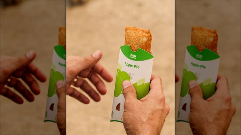 Hand holding fried McDonald's apple pie