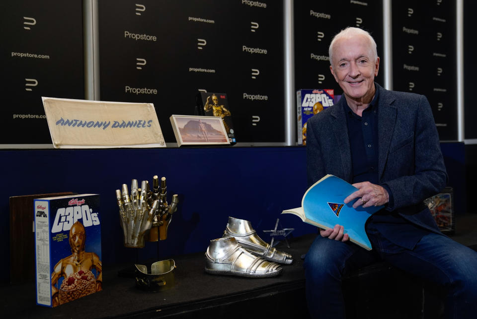 Anthony Daniels with an original third-draft script from the 1977 film 'Star Wars: A New Hope' (estimated £10,000 - 20,000) as he poses for a photograph alongside other pieces of Star Wars memorabilia from his personal collection, during a preview for the showbiz memorabilia auction, at the Propstore in Rickmansworth, Hertfordshire. Picture date: Wednesday September 20, 2023. (Photo by Andrew Matthews/PA Images via Getty Images)