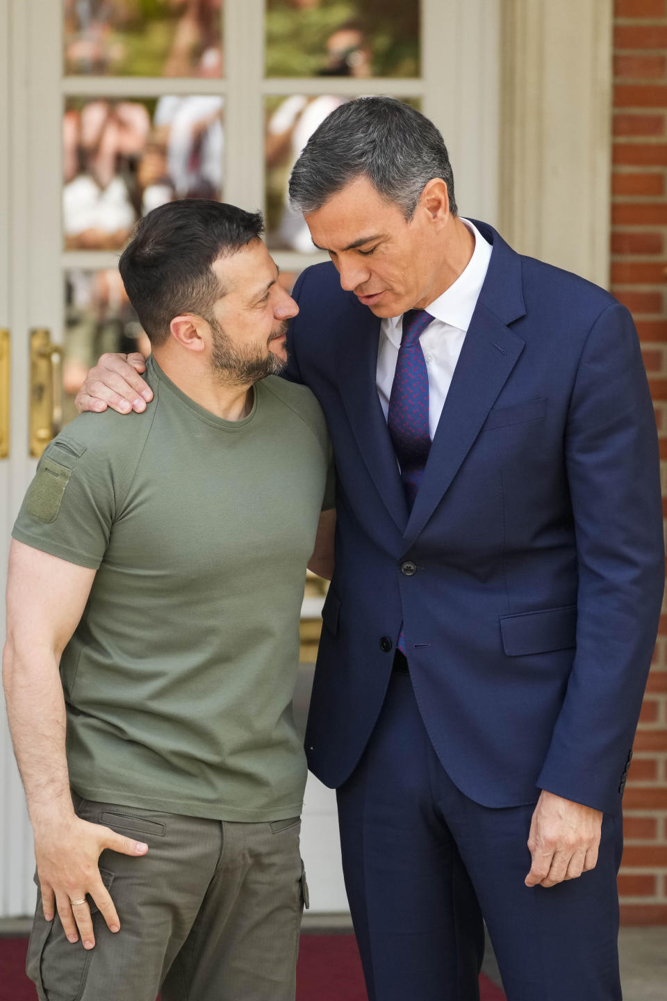 Ukrainian President Volodymyr Zelenskyy, left, is welcomed by Spain's Prime Minister Pedro Sanchez at the Moncloa palace in Madrid on Monday, May 27, 2024. (AP Photo/Paul White)