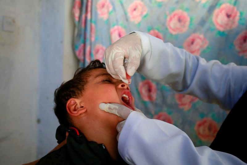 FILE PHOTO: Boy receives a polio vaccine during a three-day immunization campaign in Sanaa