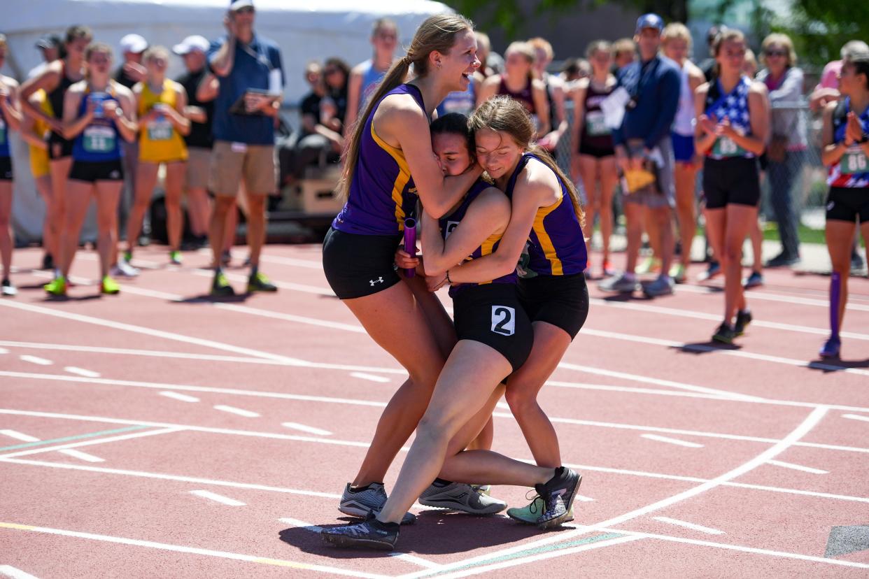 Watertown's Victoria Smith collapses into the arms of teammates Emma List (left) and Kate McElroy after the Arrows finished first in their heat of the Class AA girls 3,200-meter relay on first day of state track on Thursday at Howard Wood Field in Sioux Falls. The Watertown relay, which also included Kristen Schulte, ended up placing eighth in the event.