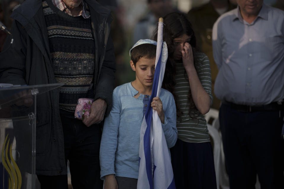 A brother of the Israeli Captain Neriya Zisk mourns during his funeral at a cemetery in the village of Masu'ot Yitzhak, Israel, Thursday, Dec. 28, 2023. Zisk was killed in combat in the Gaza Strip. (AP Photo/Leo Correa)