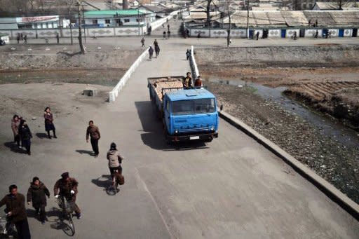 North Koreans are seen from the window of a train along the railway line between Pyongyang and the North Phyongan Province. North Korea is hardly known for offering a warm welcome to the world's press, and never before has it given access to a sensitive site featuring its latest space hardware