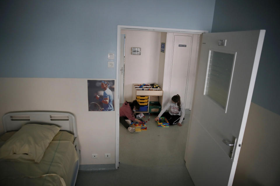 Children play in a corridor at the pediatric unit of the Robert Debre hospital, in Paris, France, Tuesday, March 2, 2021. The Paris pediatric hospital, the busiest of its type in France, has seen a doubling in the number of children and young teenagers requiring treatment after attempted suicides since September. (AP Photo/Christophe Ena)