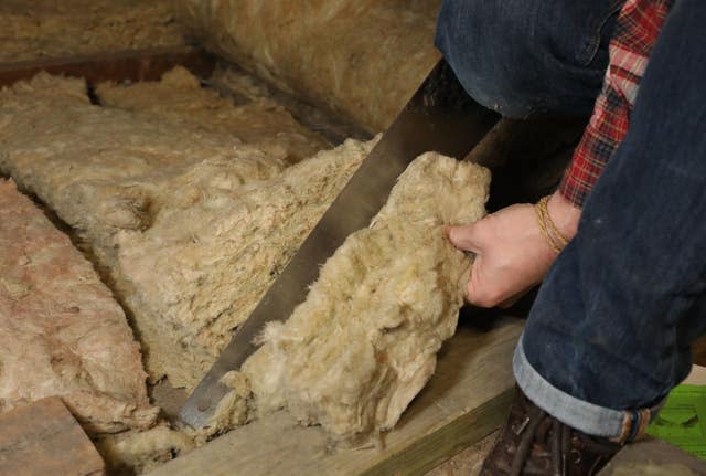 Insulation being laid in a loft