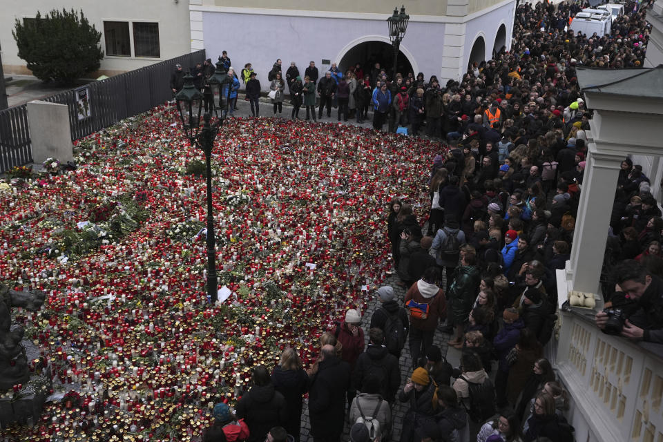 People gather in front of headquarters of Charles University in Prague, Czech Republic, Thursday, Jan. 4, 2024. Thousands of students and other Czechs marched in silence in the Czech capital on Thursday to honor the victims of the country's worst mass killing that left 14 dead on Dec. 21, 2023. (AP Photo/Petr David Josek)