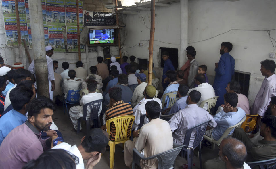 People watch cricket World Cup match between Pakistan and India, at a tea-stall in Karachi, Pakistan, Sunday, June 16, 2019. (AP Photo/Fareed Khan)