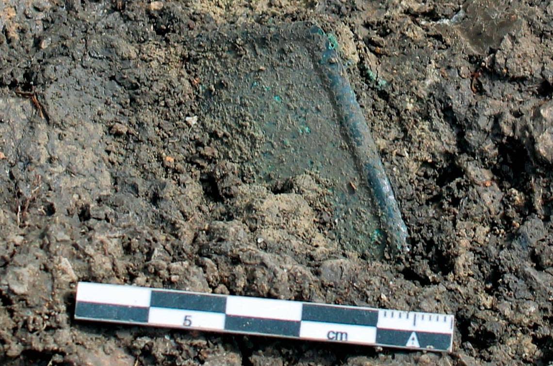 The bronze hand before archaeologists excavated the object.