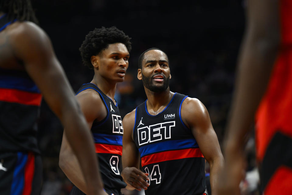 Detroit Pistons guard Alec Burks (14) reacts as teammate Ausar Thompson (9) looks on after being fouled during the first half of an NBA basketball game against the Toronto Raptors in Toronto on Sunday, Nov. 19, 2023. (Christopher Katsarov/The Canadian Press via AP)