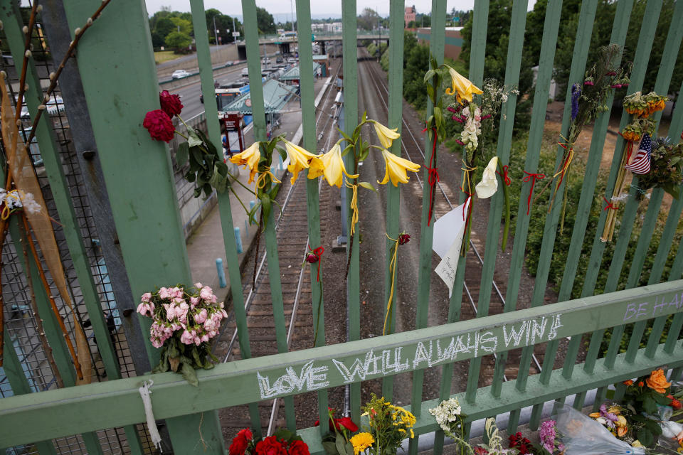 Flowers hang on a makeshift memorial