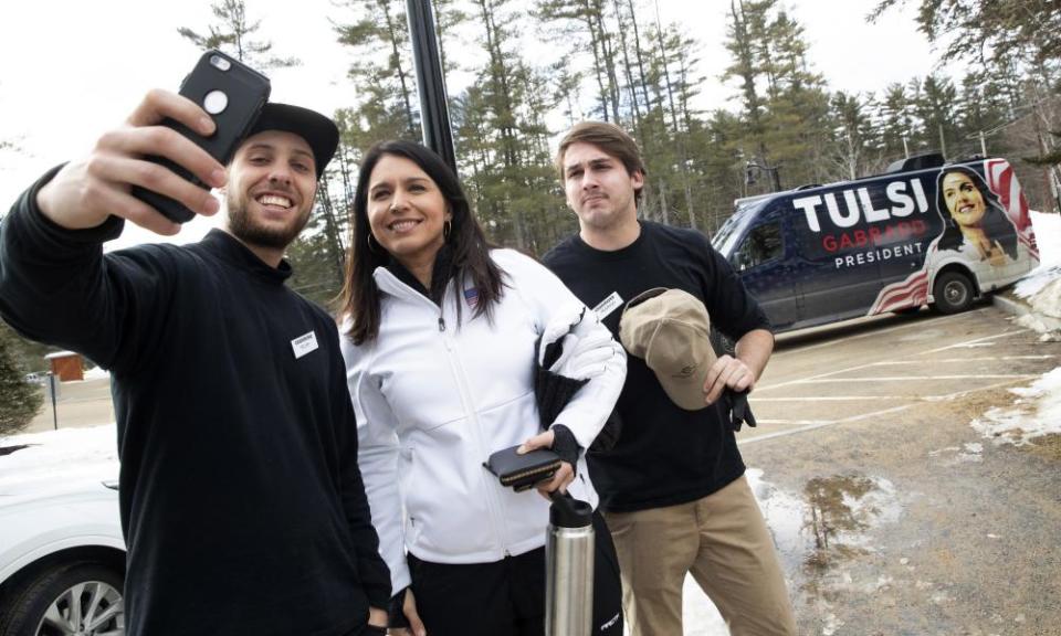 Tulsi Gabbard takes a selfie with members of the staff at Cranmore Mountain Resort on 28 January 2020 in North Conway, New Hampshire.