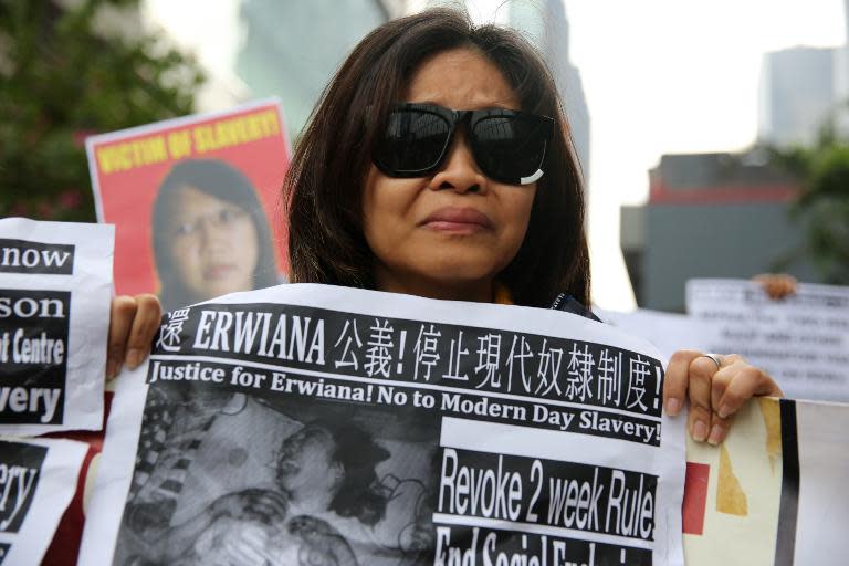 A member of a support group for Indonesian maid Erwiana Sulistyaningsih, who allegedly was abused by her employers, protests outside the Wanchai law courts in Hong Kong, on December 8, 2014