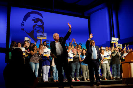 FILE PHOTO: (L-R) U.S. Senator Bernie Sanders and Democrat Greg Edwards, Pennsylvania's 7th District Congressional candidate, wave to supporters during a rally in Allentown, Pennsylvania, U.S. May 5, 2018. REUTERS/Mark Makela