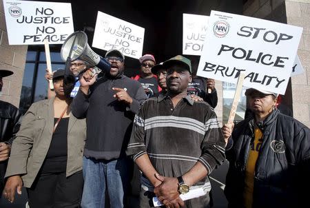 Floyd Dent (2nd R) takes part in a protest against police brutality outside the Inkster Police Department in Inkster, Michigan April 1, 2015. REUTERS/ Rebecca Cook