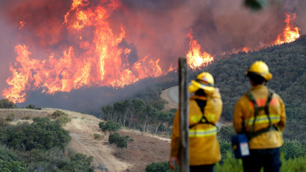 Mandatory Credit: Photo by JOHN G MABANGLO/EPA-EFE/REX/Shutterstock (9775255d)A hillside erupts in flames from the River Fire as fire fighters look on in Lakeport, California, USA, 31 July 2018.