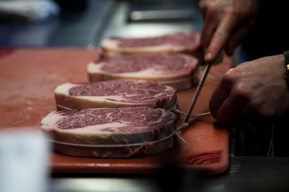 Brian Baxter prepares steaks at The Catbird Seat in Nashville, Tenn., Thursday, May 16, 2024.