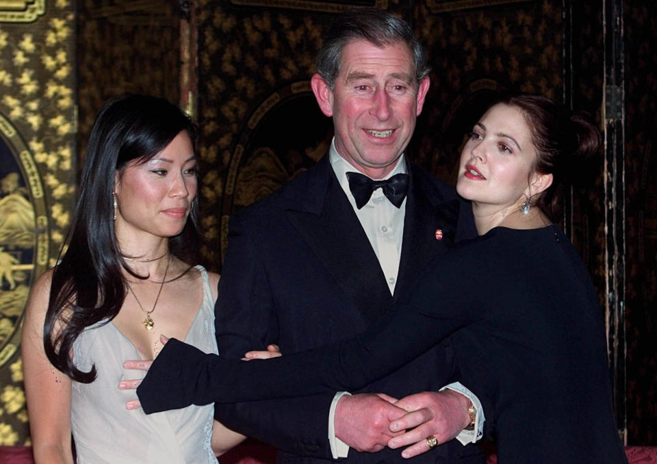 The Prince of Wales, flanked by Lucy Liu, (left) as Drew Barrymore (right) hits Liu in an attempt to give Prince Charles a hug prior to a dinner at St. James's Palace in London.   *...Prince Charles hosted a dinner ahead of the Prince's Trust premiere of 'Charlie's Angels' in London.   (Photo by PA Images via Getty Images)