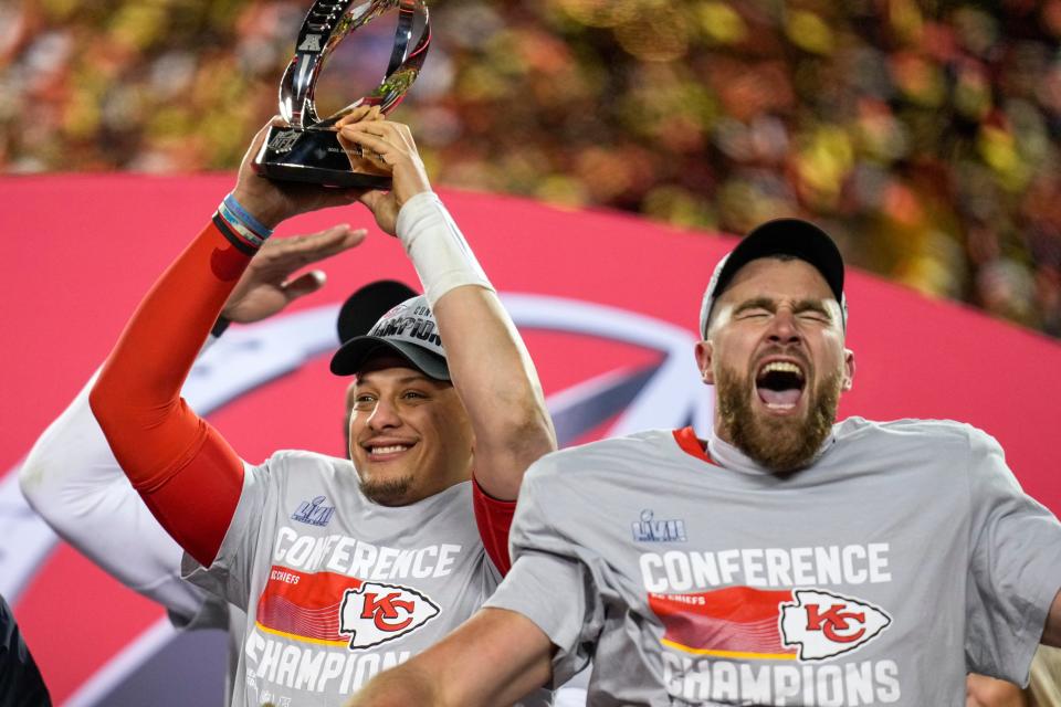 Kansas City Chiefs quarterback Patrick Mahomes (15) raises the Lamar Hunt Trophy with tight end Travis Kelce (87) after the AFC championship NFL game between the Cincinnati Bengals and the Kansas City Chiefs, Sunday, Jan. 29, 2023, at Arrowhead Stadium in Kansas City, Mo. The Kansas City Chiefs advanced to the Super Bowl with a 23-20 win over the Bengals. (Via OlyDrop)