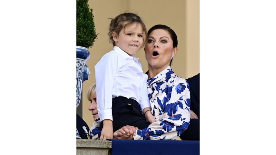 Prince Alexander being held up by Crown Princess Victoria