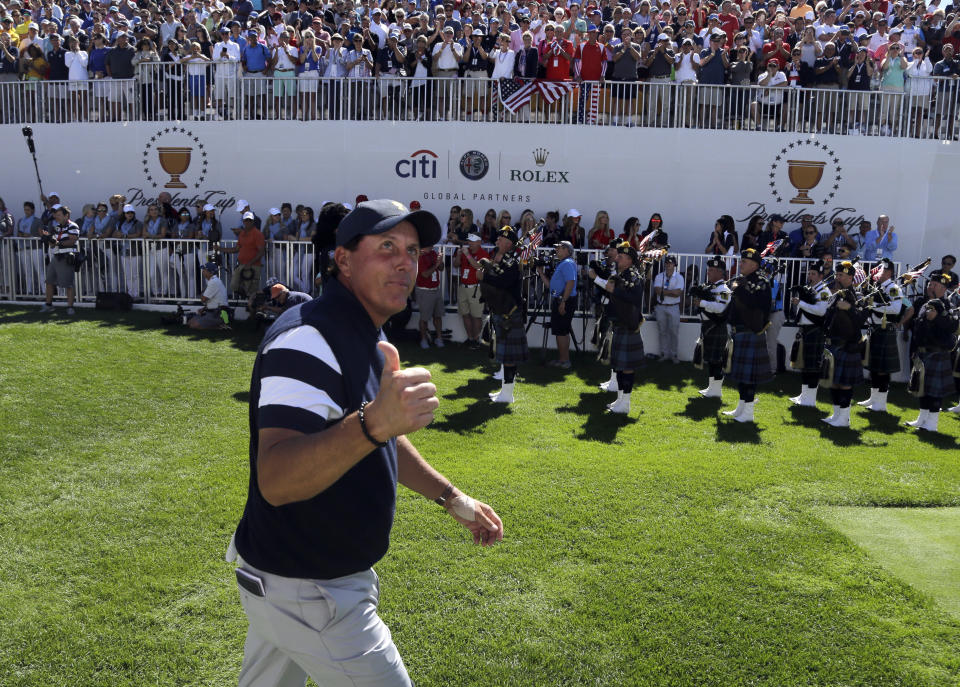 <p>Phil Mickelson acknowledges the crowd on the first tee during the first round of the Presidents Cup at Liberty National Golf Club in Jersey City, N.J., Sept. 28, 2017. (Photo: Julio Cortez/AP) </p>