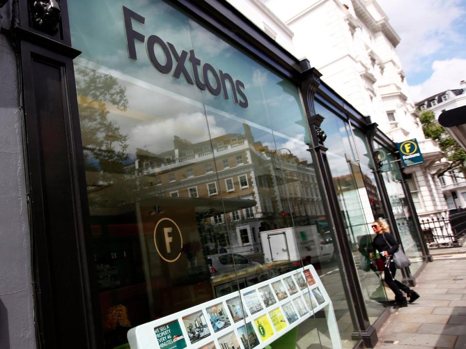 A woman walks into a Foxtons estate agent in west London, Britain July 29, 2016