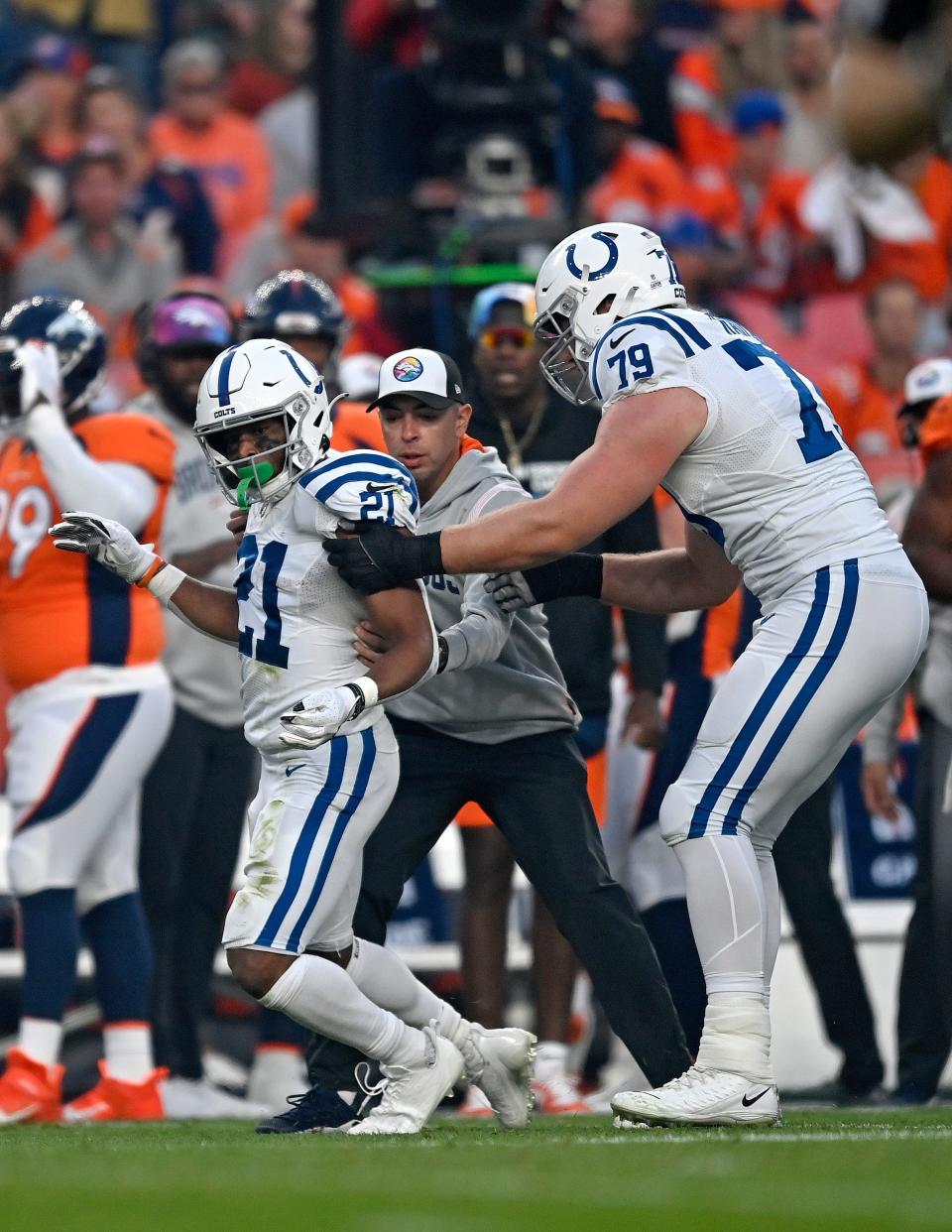 Nyheim Hines is helped to his feet early in Thursday night's game against the Broncos.