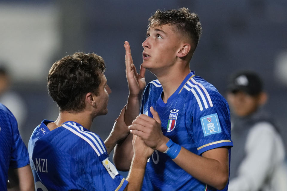 Italy's Francesco Esposito, right, celebrates with teammate Tommaso Baldanzi after scoring his side's third goal against Colombia during a FIFA U-20 World Cup quarterfinal soccer match at the Bicentenario stadium in San Juan, Argentina, Saturday, June 3, 2023. (AP Photo/Ricardo Mazalan)